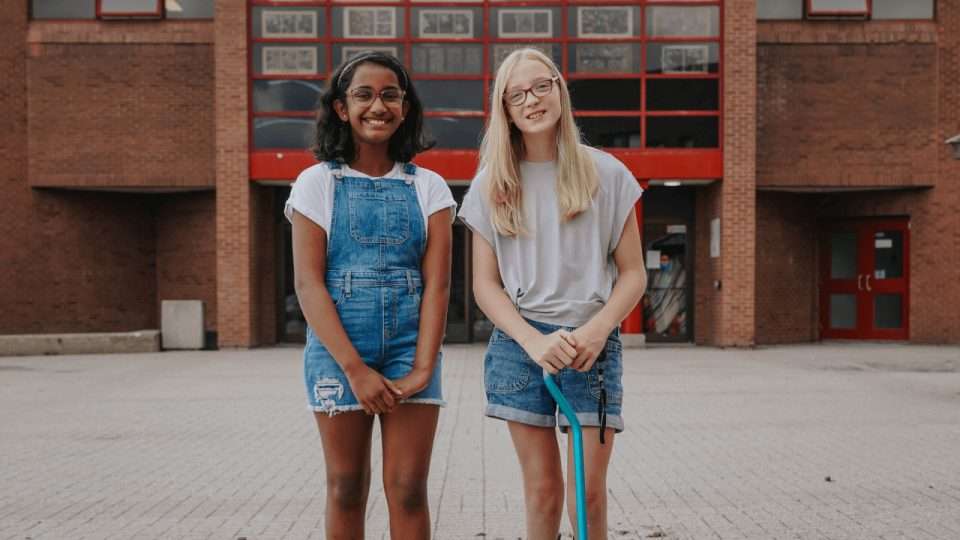 two OCSB students in front of a School