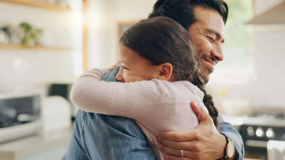 father hugging his child