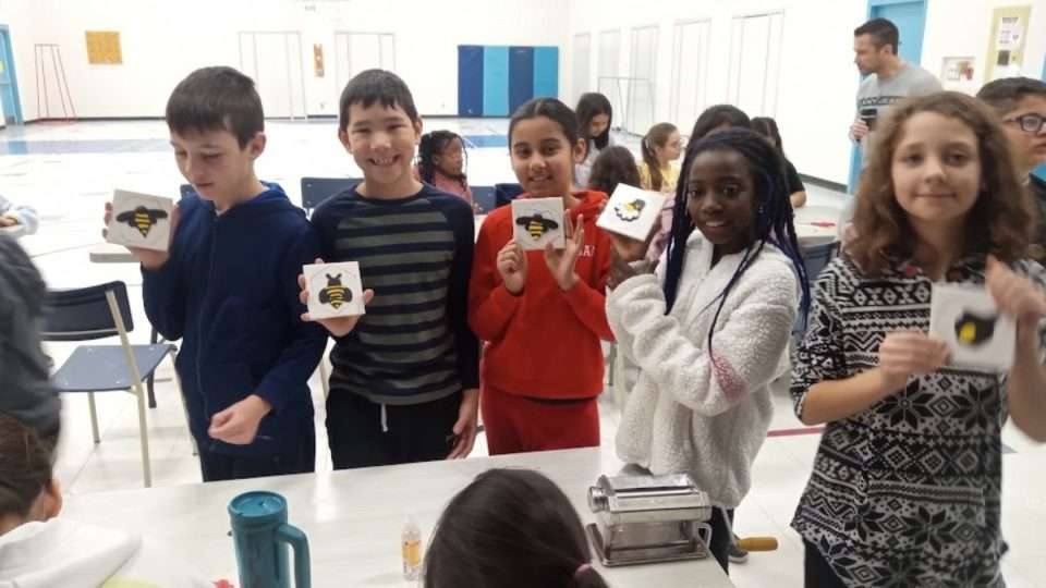 OCSB Students holding a card with BEE logo