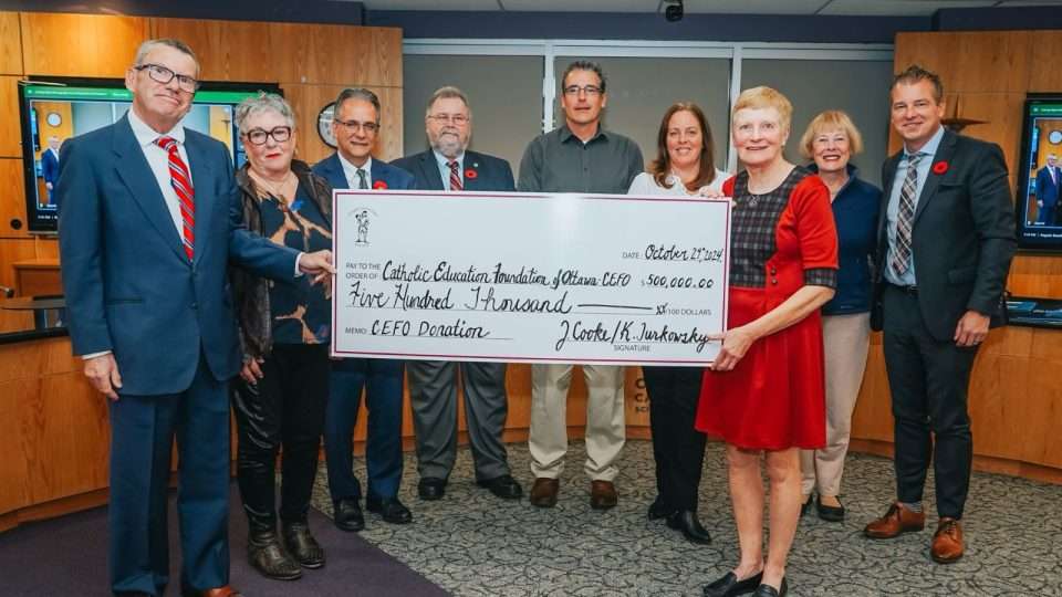 CEFO team holding a donation cheque