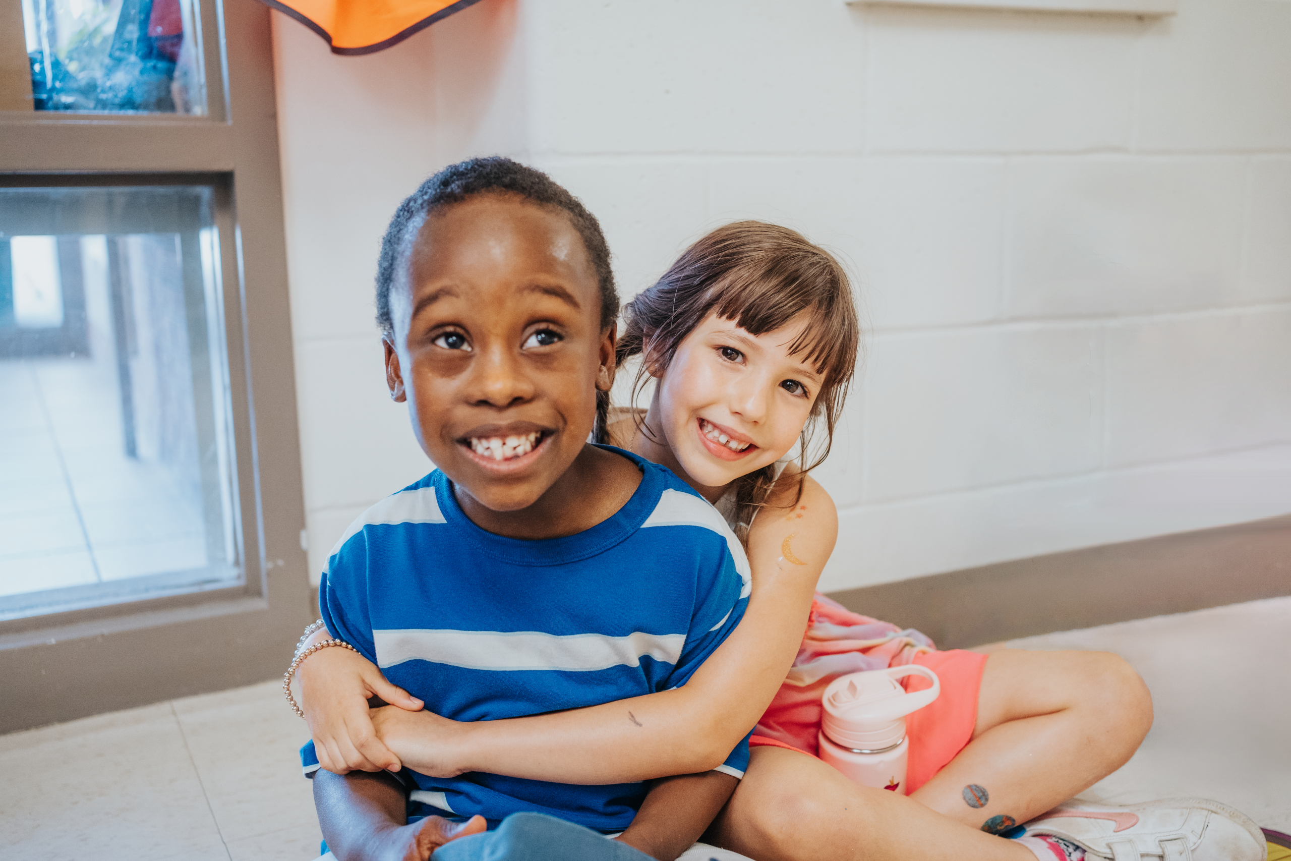 A child hugging another child at an OCSB school
