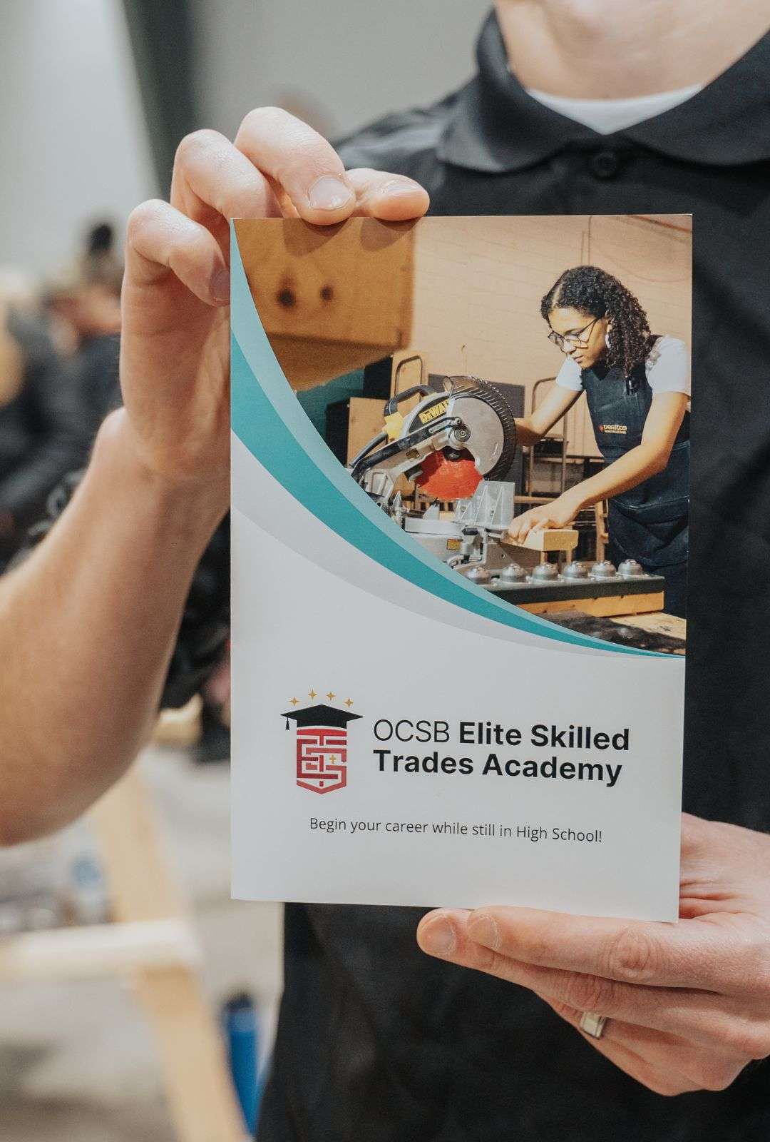 ESTA staff member holding a brochure