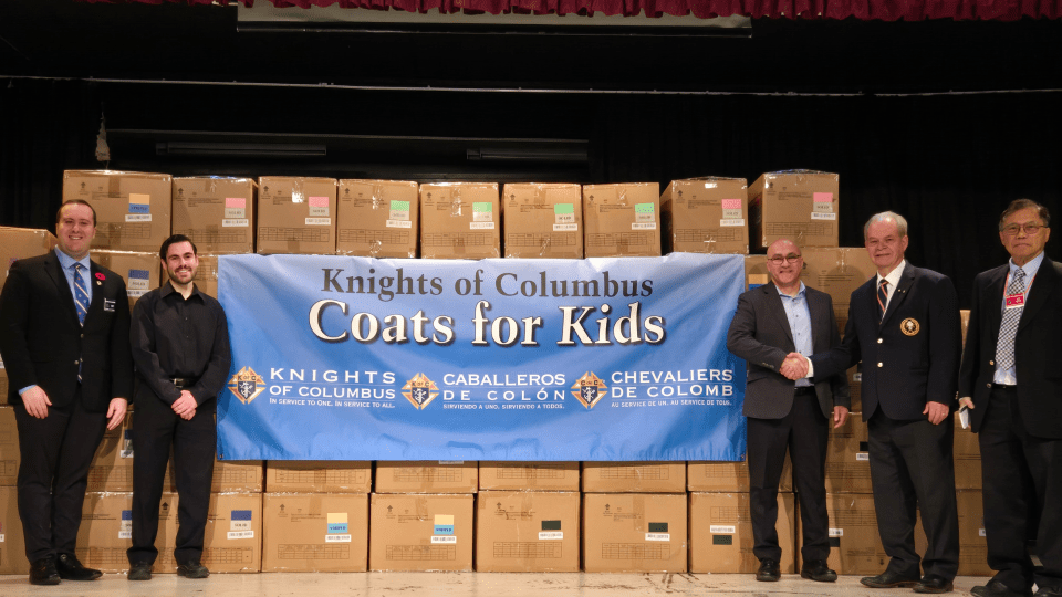 Coats for Kids leaders and OCSB staff with boxes of coats to donate