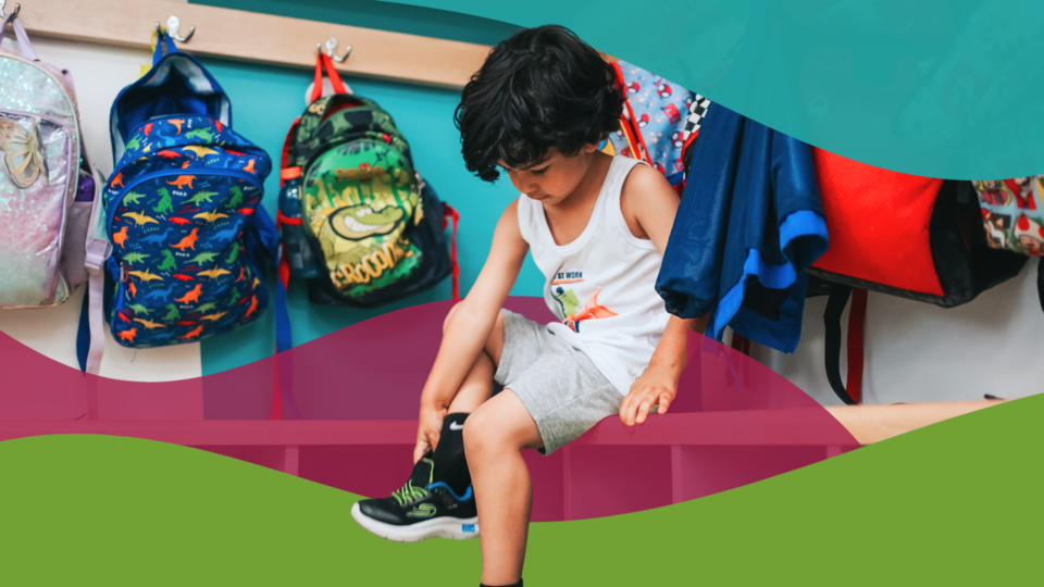OCSB student in his classroom putting on his shoes