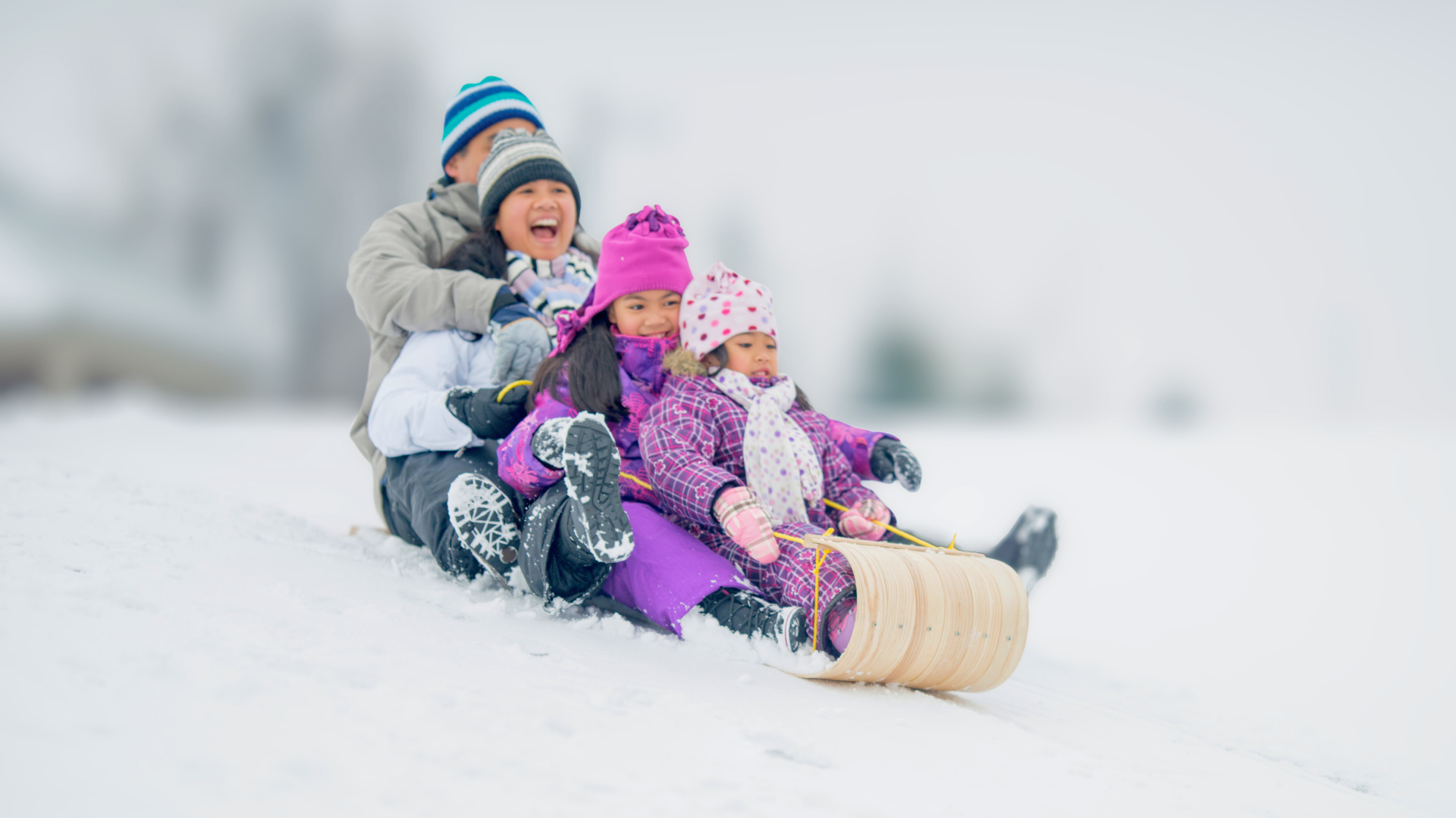 family playing in the snow