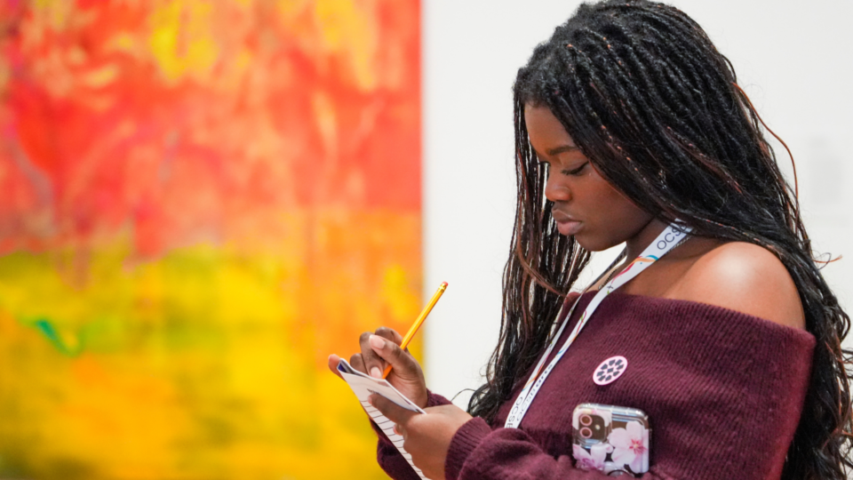 A young artist looking at an artwork at the National Art Gallery