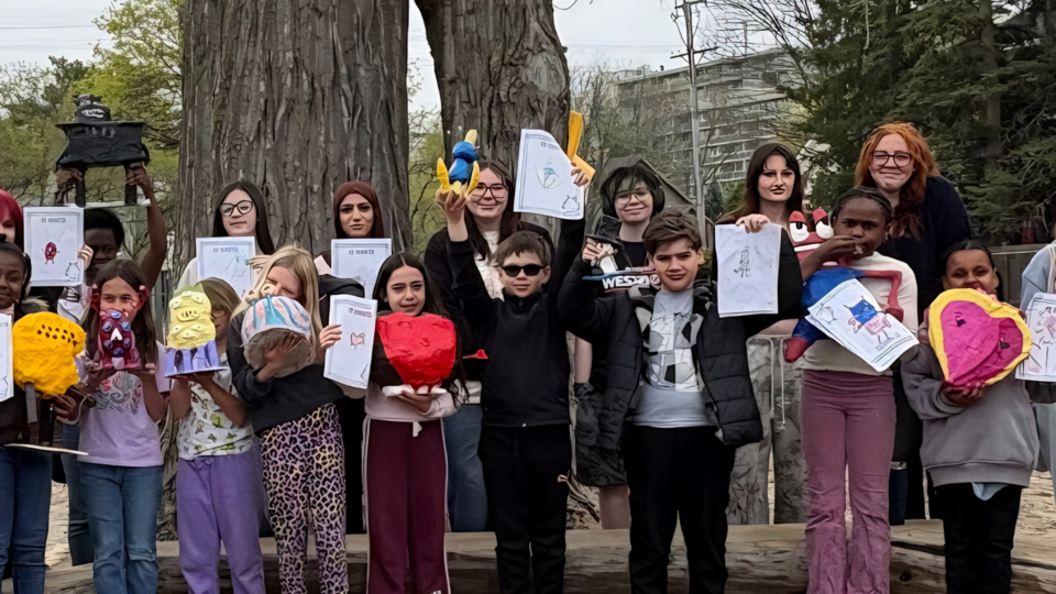 OCSB students outdoors showing the Monster drawing and the 3D version