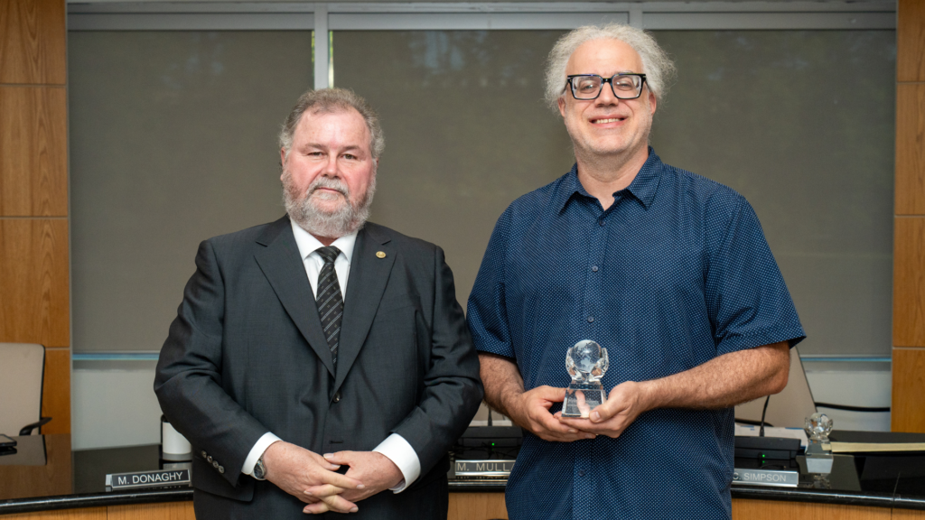 Tony Dunn receives the award on behalf of his mother, MaryAnn, in recognition of her meaningful contributions and lasting impact.